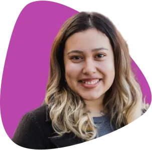 Leslie Sanchez, smiling, with long wavy hair.