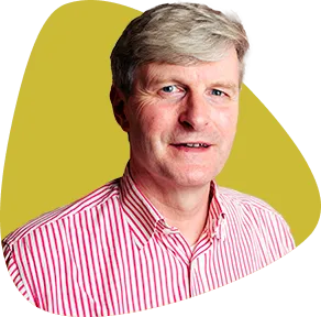 Philipp Matushka, smiling, with grey hair and wearing a striped shirt.