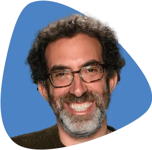 Peter Steinberg, with curly hair, glasses, and a full beard.