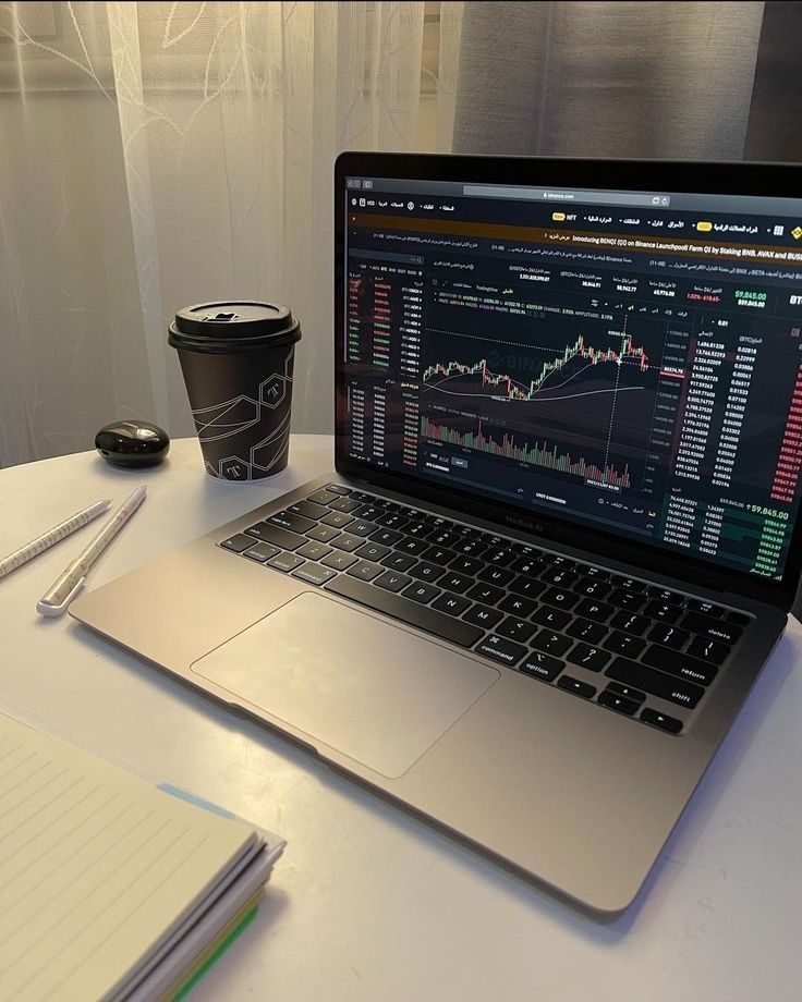 a laptop with a chart on a table